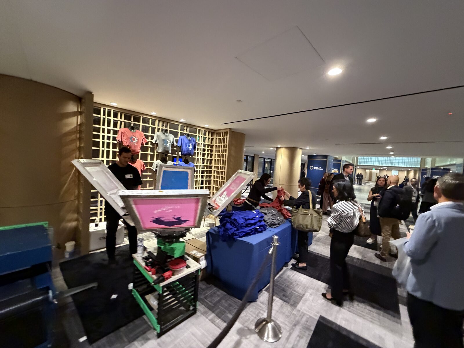 Branded corporate merch printing booth set up at a company event