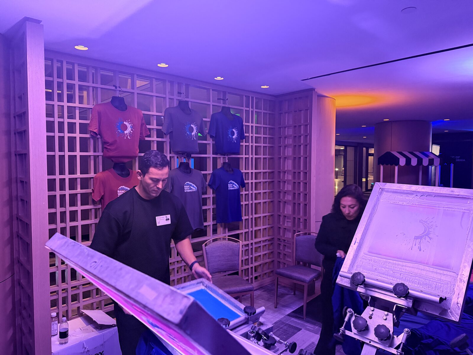 Event shirt wall showing printed company designs on display
